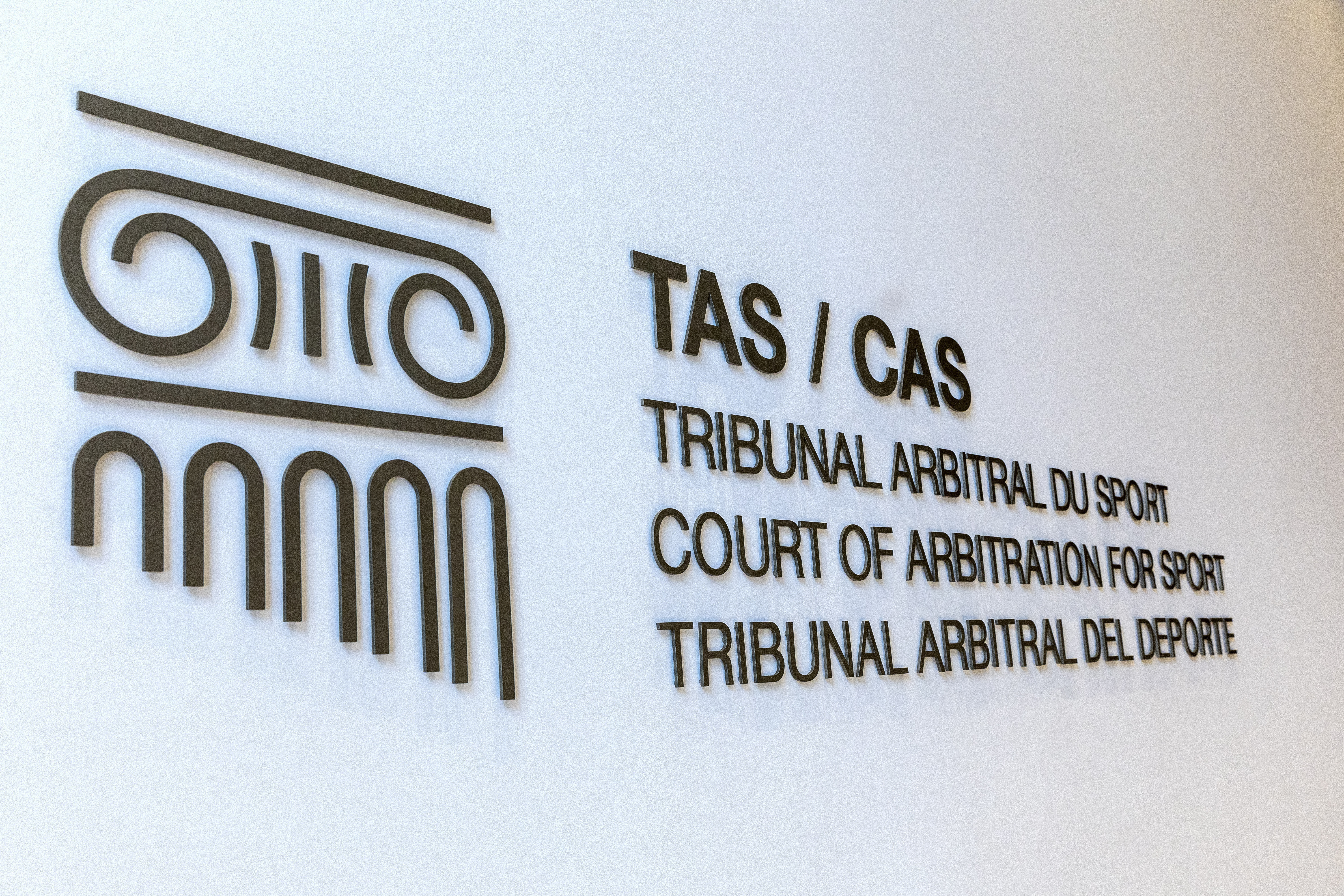 FILE PHOTO: A logo is pictured on the new headquarters for the Court of Arbitration for Sport (CAS), an independent institution that resolves around 900 legal disputes in the field of sport through arbitration and mediation, in Lausanne, Switzerland, June 27, 2022.  REUTERS/Denis Balibouse